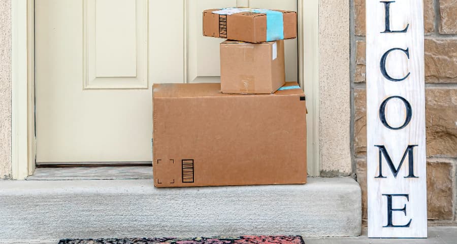 Packages on the doorstep of a home with a welcome sign in Sandy Springs